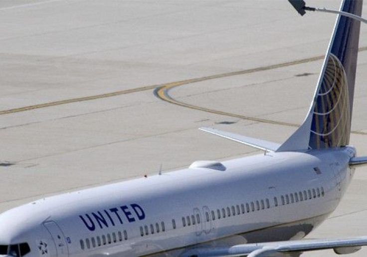 A United Airlines plane with the Continental Airlines logo on its tail, sits at a gate at O'Hare International airport in Chicago October 1, 2010