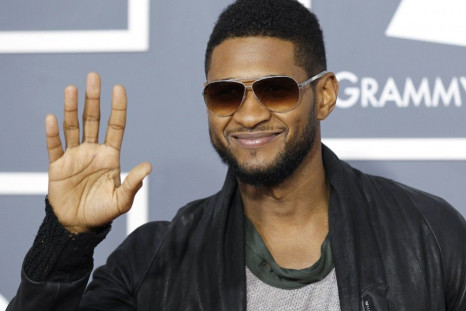 Usher poses on arrival at the 53rd annual Grammy Awards in Los Angeles