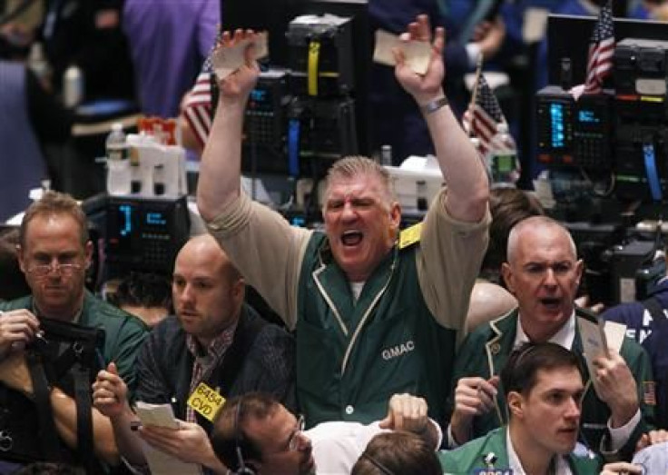 Traders gesture at each other while working in the crude oil and natural gas options pit on the floor of the New York Mercantile Exchange