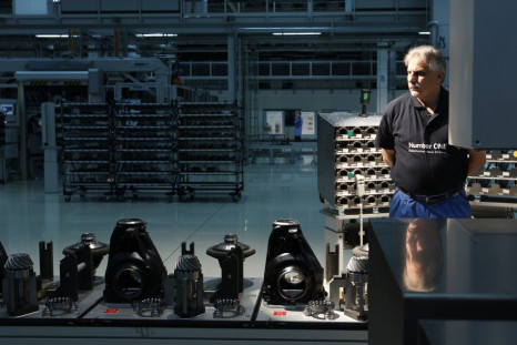Employee Josef Kronschnabel stands next to the new axle gearing production line in Dingolfing