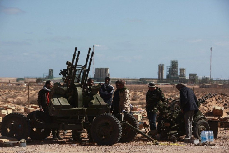 Anti-Gaddafi rebels take up position near the oil facility of Ras Lanuf March 6, 2011. 