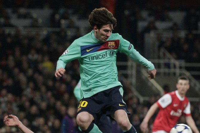 Arsenal's van Persie fights for the ball against Barcelona's Messi during their Champions League soccer match in London.