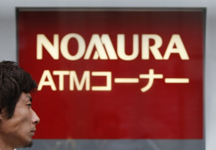 A man walks past a Nomura Securities branch in Tokyo