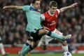 Xavi and Wilshere battle for the ball in the first leg of the tie.