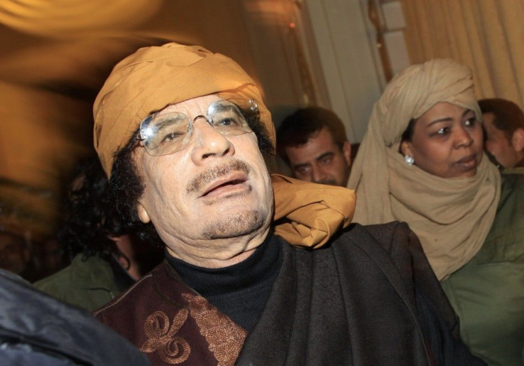 Libya's leader Moammar Gaddafi arrives to give television interviews at a hotel in Tripoli