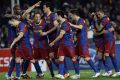 Barcelona players celebrate after scoring a goal during their Champions League soccer match in Barcelona.