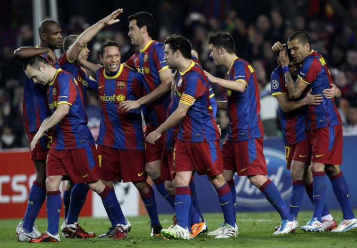 Barcelona players celebrate after scoring a goal during their Champions League soccer match in Barcelona.