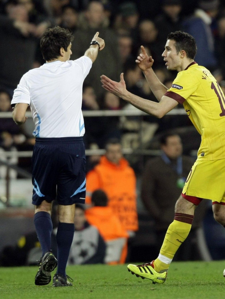 Arsenal's Robin Van Persie argues with referee Busacca after receiving a red card in Arsenal's Champions League encounter against Barcelona.