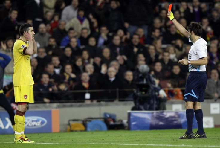 Massimo Busacca shows a red card to Arsenal's van Persie during their Champions League soccer match against Barcelona in Barcelona.