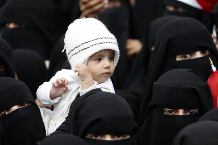 Woman holds up her daughter during a rally to demand the ouster of Yemen's President Ali Abdullah Saleh outside Sanaa University 