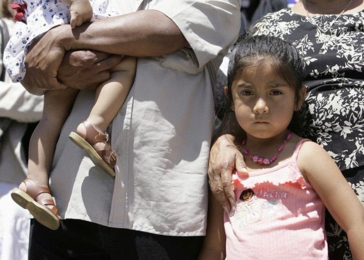 The five-year-old daughter of Juan stands between her father and her grandmother in front of La Plaza Methodist Church during the public launch of The New Sanctuary Movement in Los Angeles
