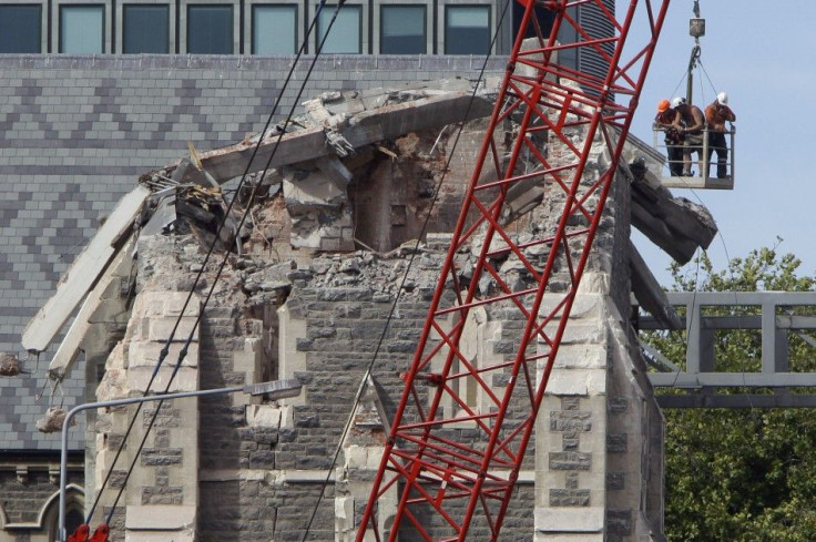 Recovery workers inspect the fallen spire of the Christchurch Cathedral in Christchurch