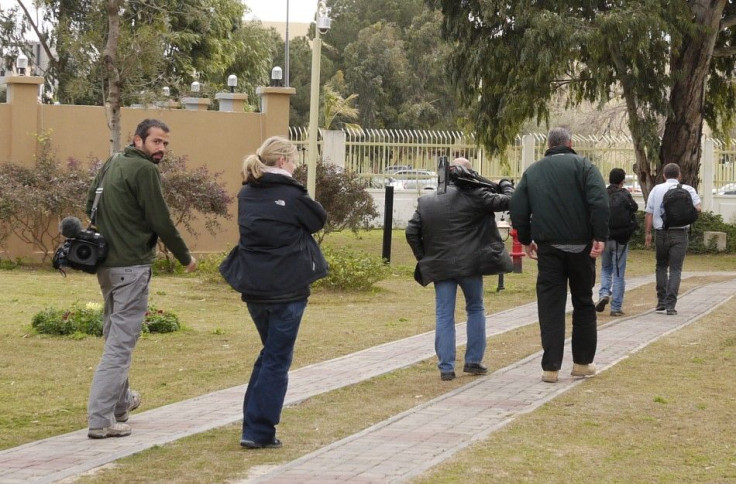 BBC cameraman Goktay Koraltan of Turkey returns to the Rixos hotel with his colleagues after being released from detention in Tripoli