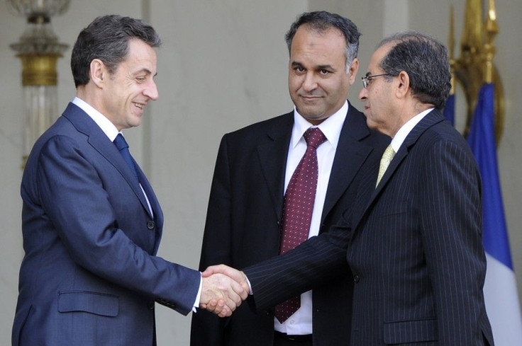 France's President Sarkozy escorts Libyan National Council emissaries and Mahmoud Jebril and Ali Essawi after a meeting at the Elysee Palace in Paris