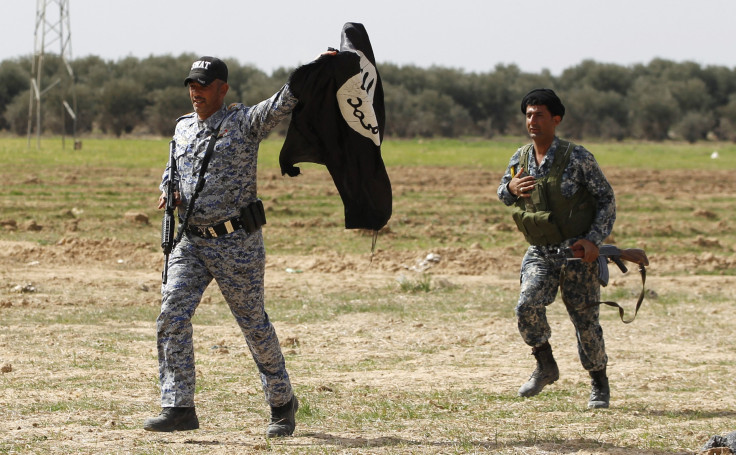security forces holding ISIS flag