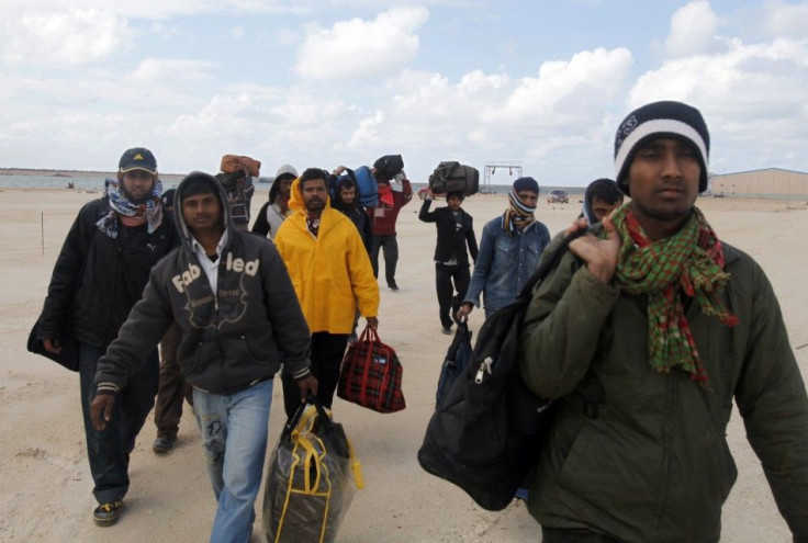 Migrant workers from Bangladesh leave the harbour in Benghazi, after failing to secure a ship to flee Libya