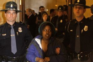Protester Brandi Collins from Milwaukee, and a student in Madison, is physically removed by Wisconsin State Troopers from the vestibule of the State Assembly Chambers of the State Capitol in Madison, Wisconsin March 10, 2011. Dozens of protesters flooded 