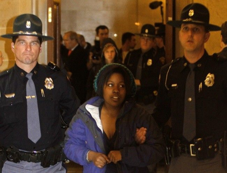 Protester Brandi Collins from Milwaukee, and a student in Madison, is physically removed by Wisconsin State Troopers from the vestibule of the State Assembly Chambers of the State Capitol in Madison, Wisconsin March 10, 2011. Dozens of protesters flooded 