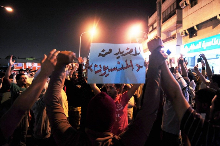 A protester holds up a placard during a demonstration demanding the release of prisoners they say are held without trial, in the Gulf coast town of Qatif