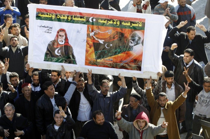 Protesters opposed to leader Muammar Gaddafi hold a poster of Omar Mokhtar in the centre of the city of Zawiyah