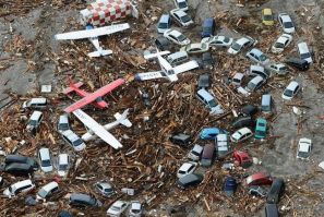Cars and airplanes swept by a tsunami are pictured among debris at Sendai Airport, northeastern Japan March 11, 2011. 