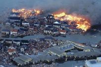 Houses swept out to sea burn following a tsunami and earthquake in Natori City in northeastern Japan March 11, 2011. 