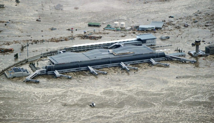 Sendai Airport is flooded after a tsunami following an earthquake in Sendai