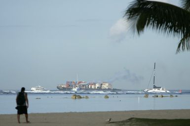 Boats leave Kewalo harbor during a tsunami warning for the Hawaiian Islands in Honolulu, Hawaii.