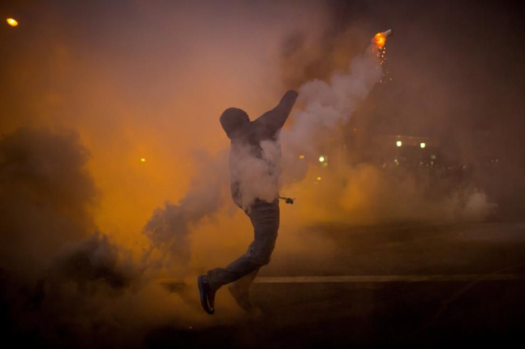 Baltimore protester throws gas cannister back at cops