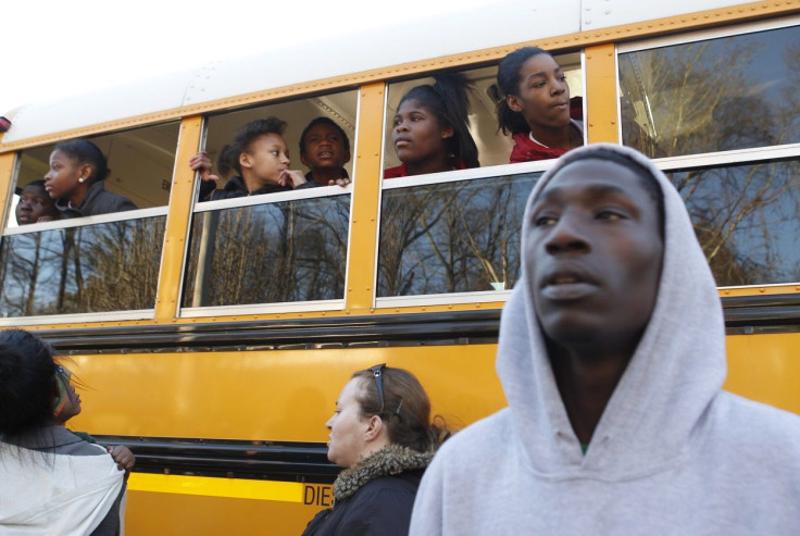 Children look for their parents from a school bus near Price Middle School following a shooting at the school in Atlanta, Georgia, January 31, 2013.