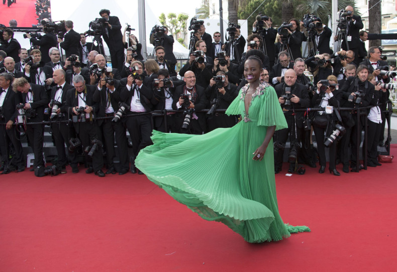 [12:50]  Actress Lupita Nyong'o poses on the red carpet as she arrives for the opening ceremony and the screening of the film "La tete haute" out of competition during the 68th Cannes Film Festival 