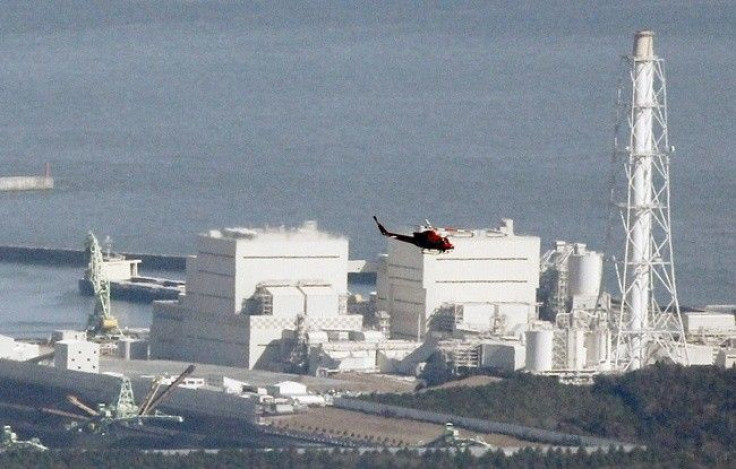 A helicopter flies past Japan's Fukushima Daiichi No.1 Nuclear reactor March 12, 2011. 