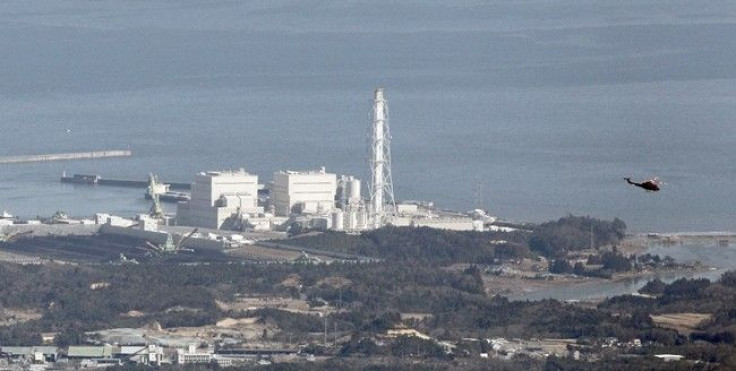 A helicopter flies past Japan's Fukushima Daiichi No.1 Nuclear reactor March 12, 2011.