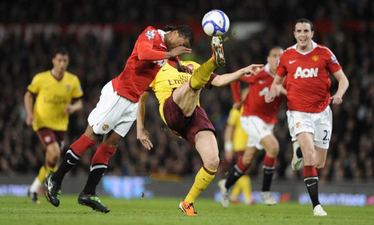 Manchester United's Patrice Evra(L) challenges Arsenal's Samir Nasri during their FA Cup quarter-final soccer match in Manchester.