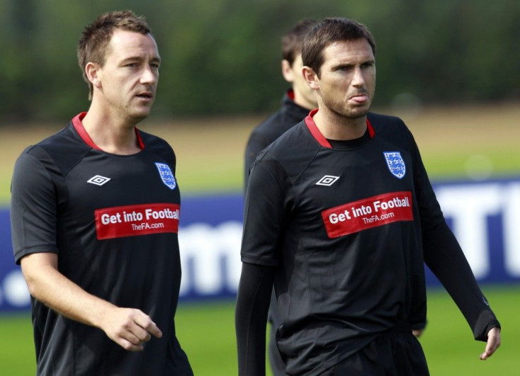 England soccer players John Terry and Frank Lampard walk on the pitch during a training session at London Colney.