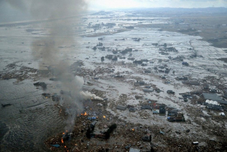 Fires burn in a harbour following an earthquake and tsunami in Natori City, Miyagi Prefecture.