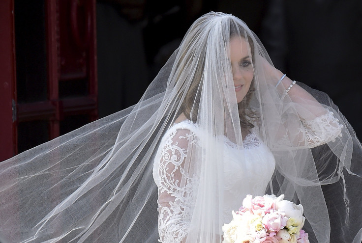 [9:03] British singer and former member of the band Spice Girls Geri Halliwell arrives for her wedding with Formula One motor racing business owner Christian Horner at St. Mary's Church at Woburn 