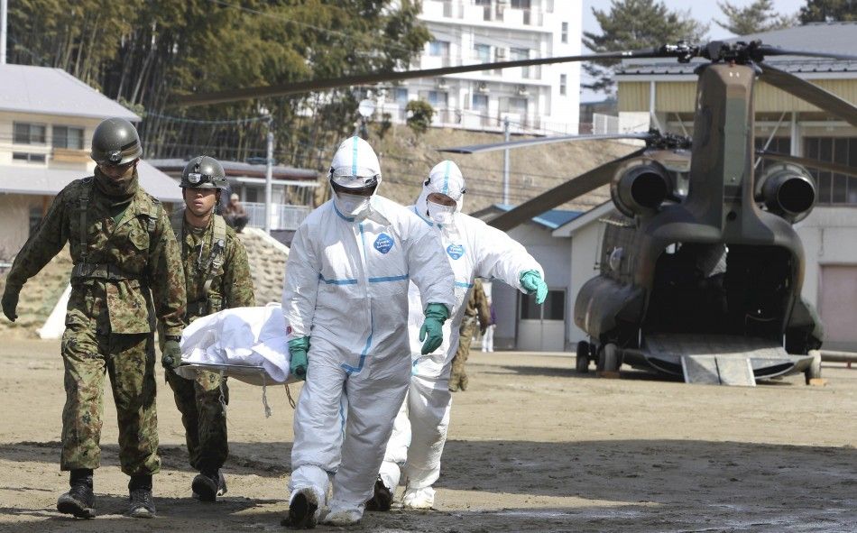 Japan Self-Defense Forces officers carry a victim who is suspected of being exposed to radiation in Nihonmatsu City