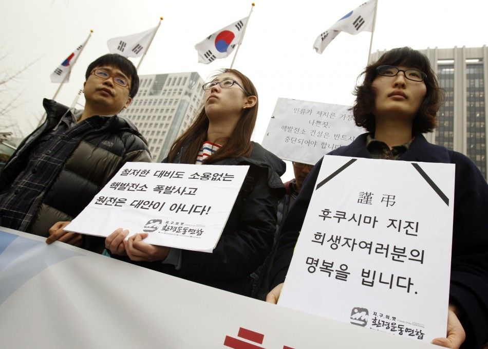 Environmental activists attend rally to mourn for victims of Japans earthquake and tsunami, and to urge South Korean government to halt building of more nuclear plants in South Korea, in Seoul