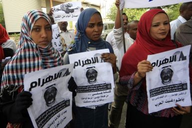 Protesters hold pictures of Al Jazeera cameramen Ali Hassan al-Jaber during a rally against the assassination of journalists in Khartoum