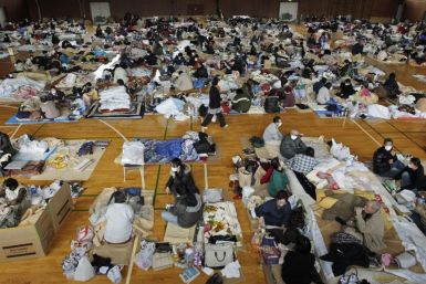 Evacuees, who fled from the vicinity of Fukushima nuclear power plant, rest at evacuation center in Kawamata