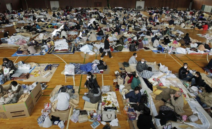 Evacuees, who fled from the vicinity of Fukushima nuclear power plant, rest at evacuation center in Kawamata