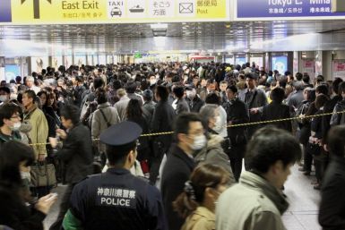 Commuters stand in line to board other trains at Yokohama Station, southwest of Tokyo