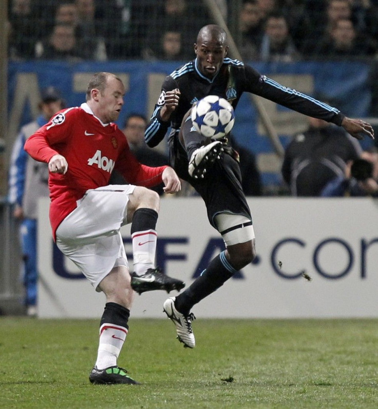 Olympique Marseille's Diawara challenges Manchester United's Rooney during their Champions League soccer match at the Velodrome stadium in Marseille.