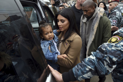 [11:13] U.S. television personality Kim Kardashian together with her rapper husband Kanye West (R) and their daughter North, gets into a car during their visit to Yot Verk Church