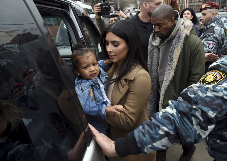 [11:13] U.S. television personality Kim Kardashian together with her rapper husband Kanye West (R) and their daughter North, gets into a car during their visit to Yot Verk Church