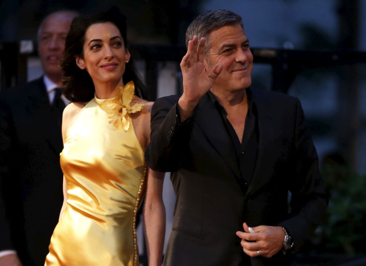 [8:46] Cast member George Clooney (R) walks with his wife Amal on the red carpet during the Japan premiere of the movie "Tomorrowland" 