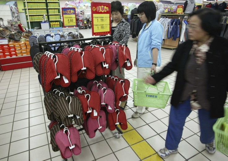Shoppers look at slippers at Times supermarket in Nanjing