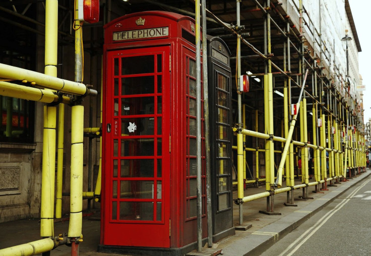 Telephone boxes are surrounded by scaffolding at a construction site in central London September 2, 2014.