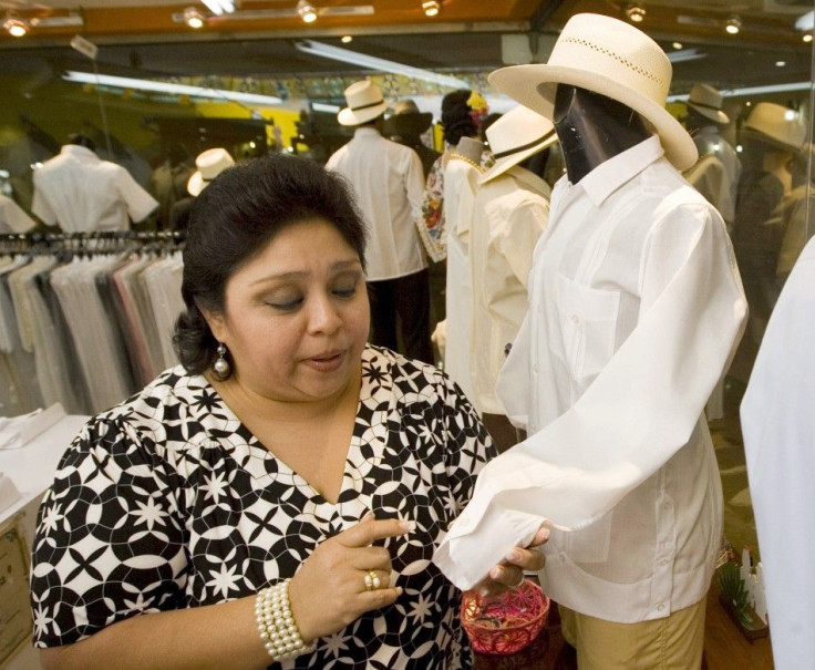 A woman looks at a guayabera shirt in a department store in Merida